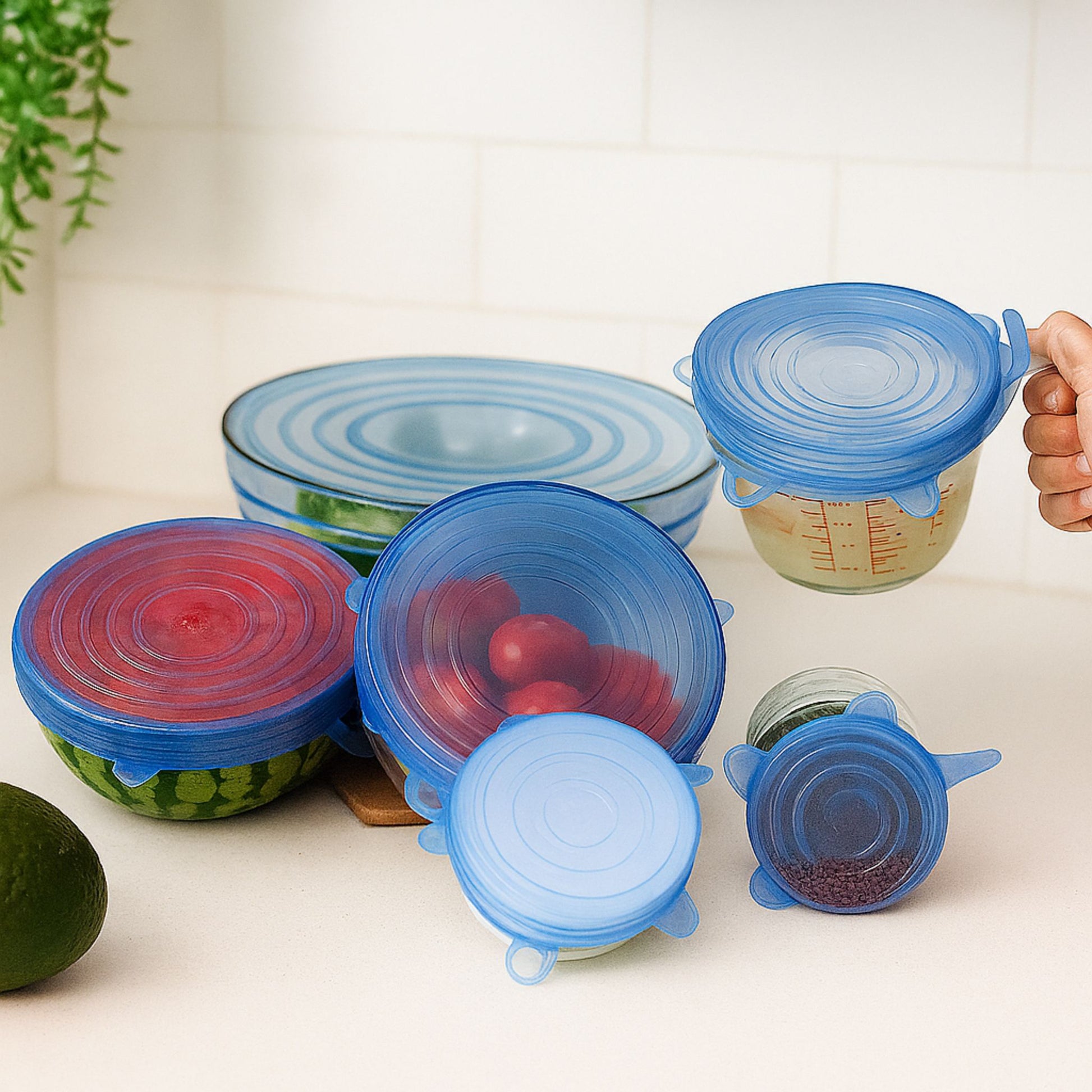 Blue silicone ZipNow stretch lids in multiple sizes on different bowls
