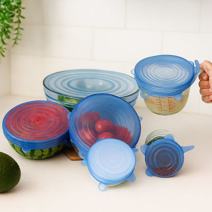 Blue silicone ZipNow stretch lids in multiple sizes on different bowls
