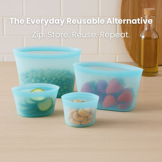 Set of green silicone food storage bags with food items on a kitchen counter.