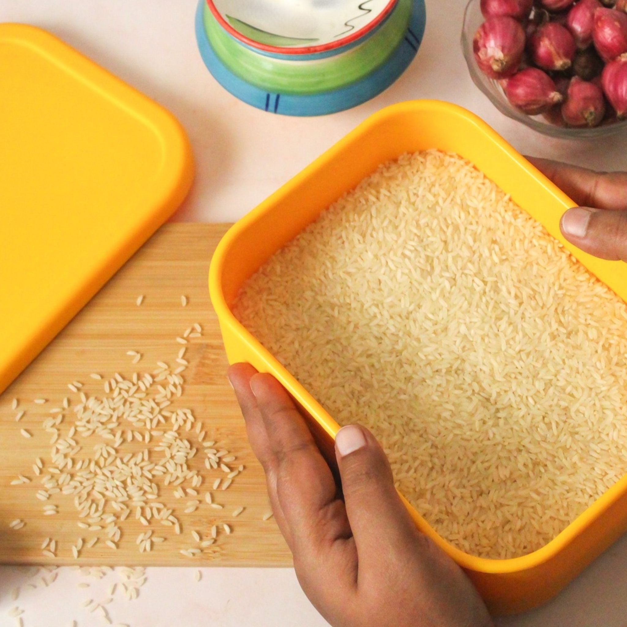 Hands holding ZipNow Silicone Rectangle Container filled with rice – food-grade and microwave-safe
