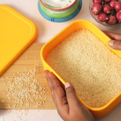 Hands holding ZipNow Silicone Rectangle Container filled with rice – food-grade and microwave-safe
