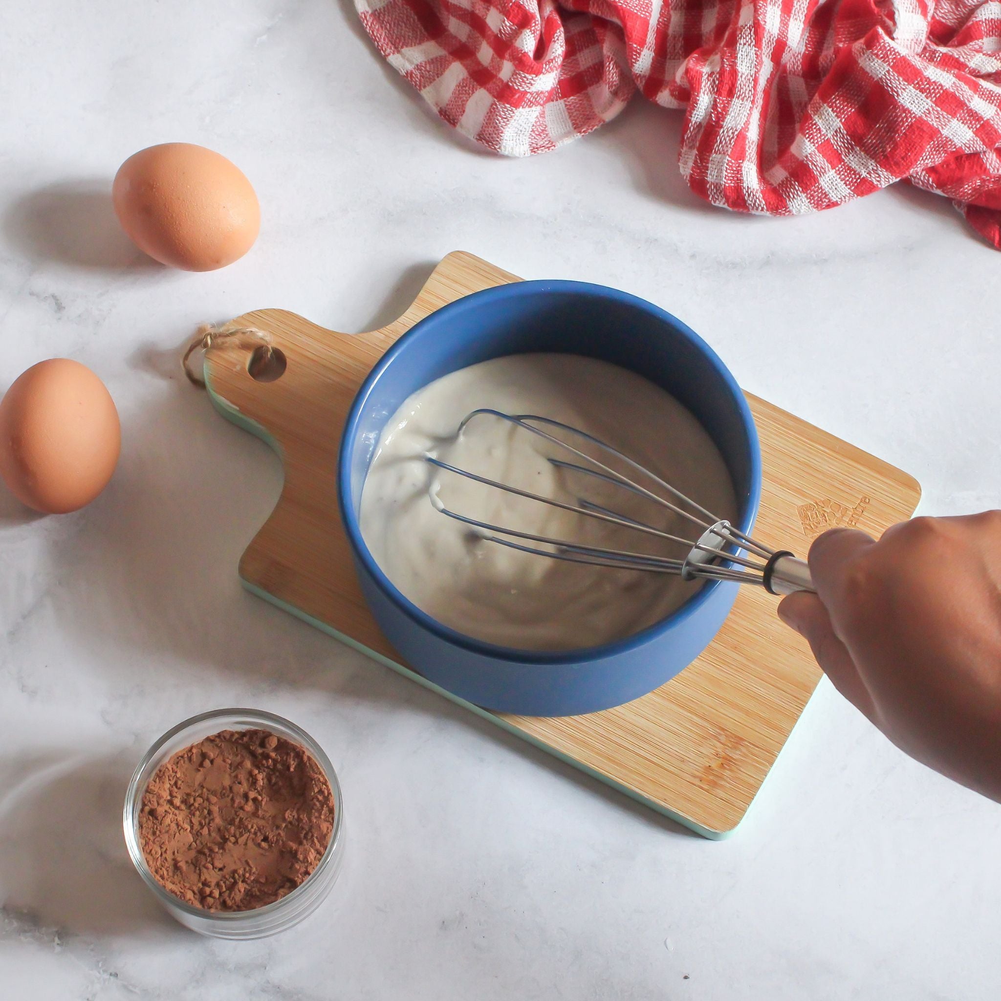 Blue ZipNow round container being used as a mixing bowl for cake batter.
