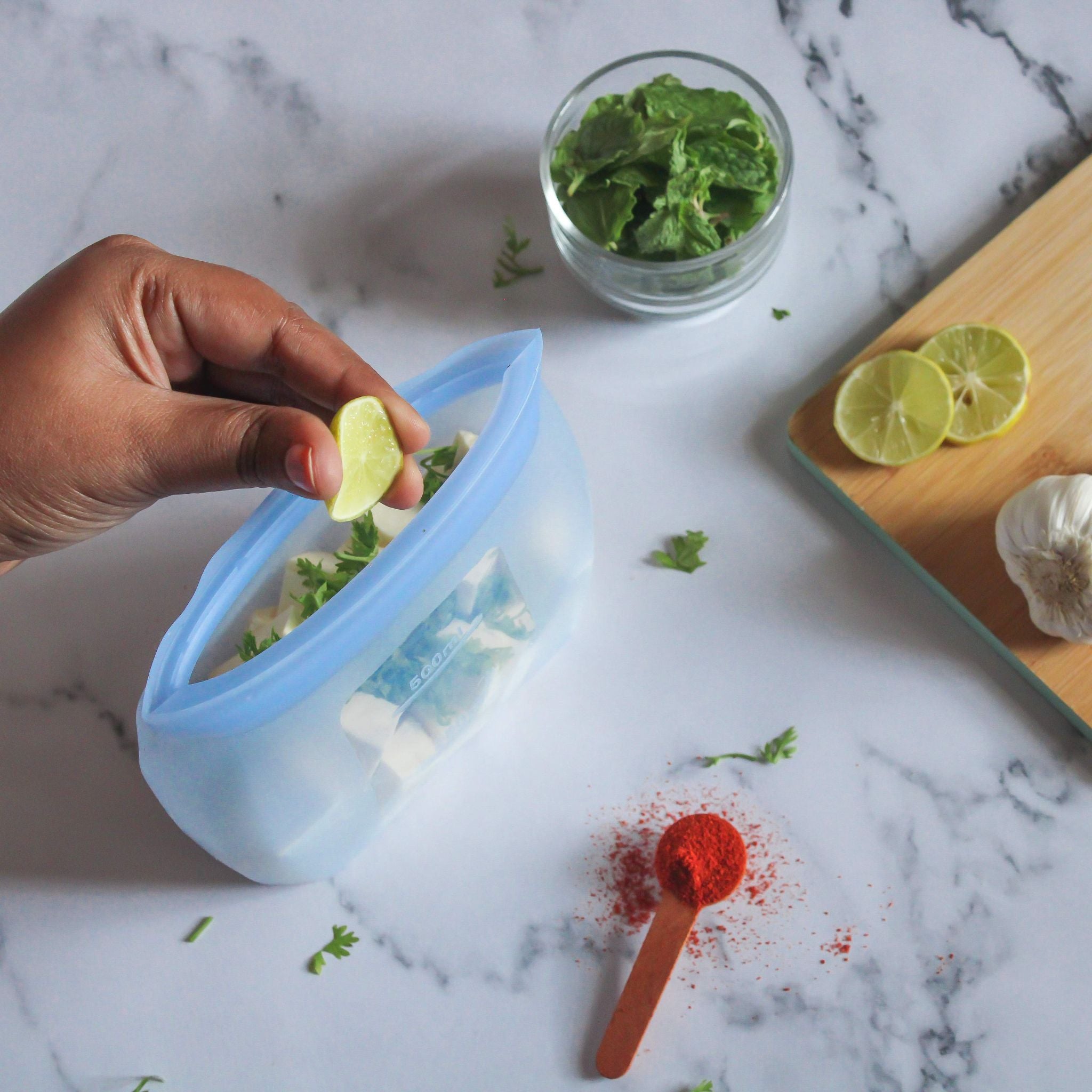 ZipNow silicone smart bag being used to prepare paneer with mint and lime – perfect for marinating and meal prep