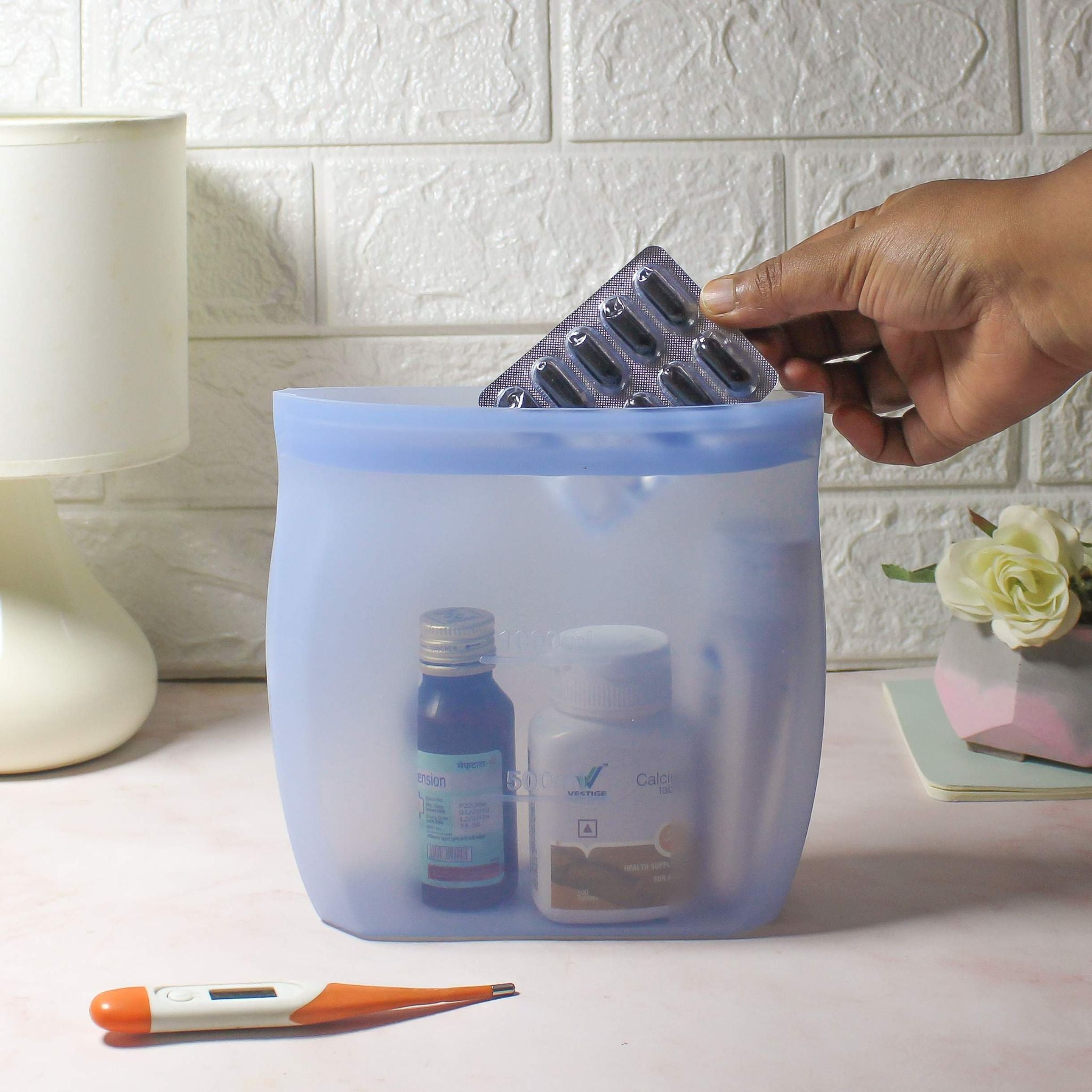 ZipNow Silicone Smart Bag used to store medicines, syrups and capsules neatly on bedside table
