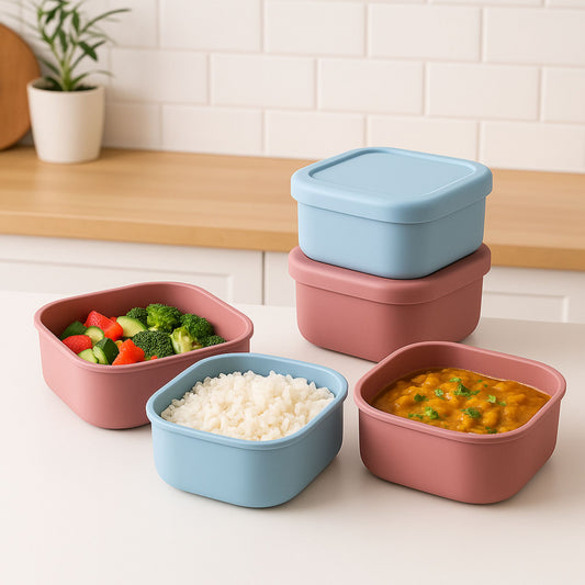 Multiple silicone square containers filled with rice, sabzi, and salad for lunch
