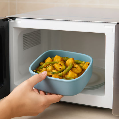 Silicone square container being placed in microwave for heating food
