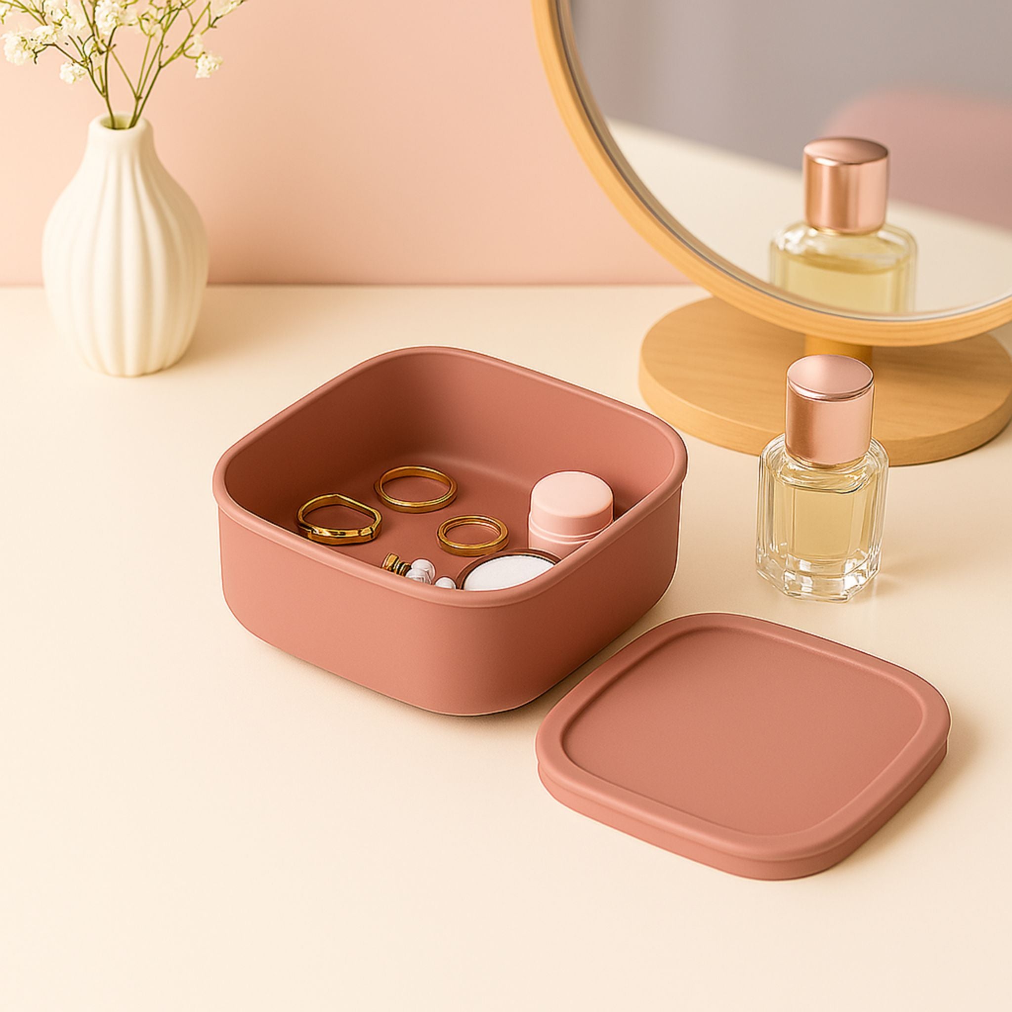 Pink ZipNow silicone container used to store jewelry and makeup on a vanity
