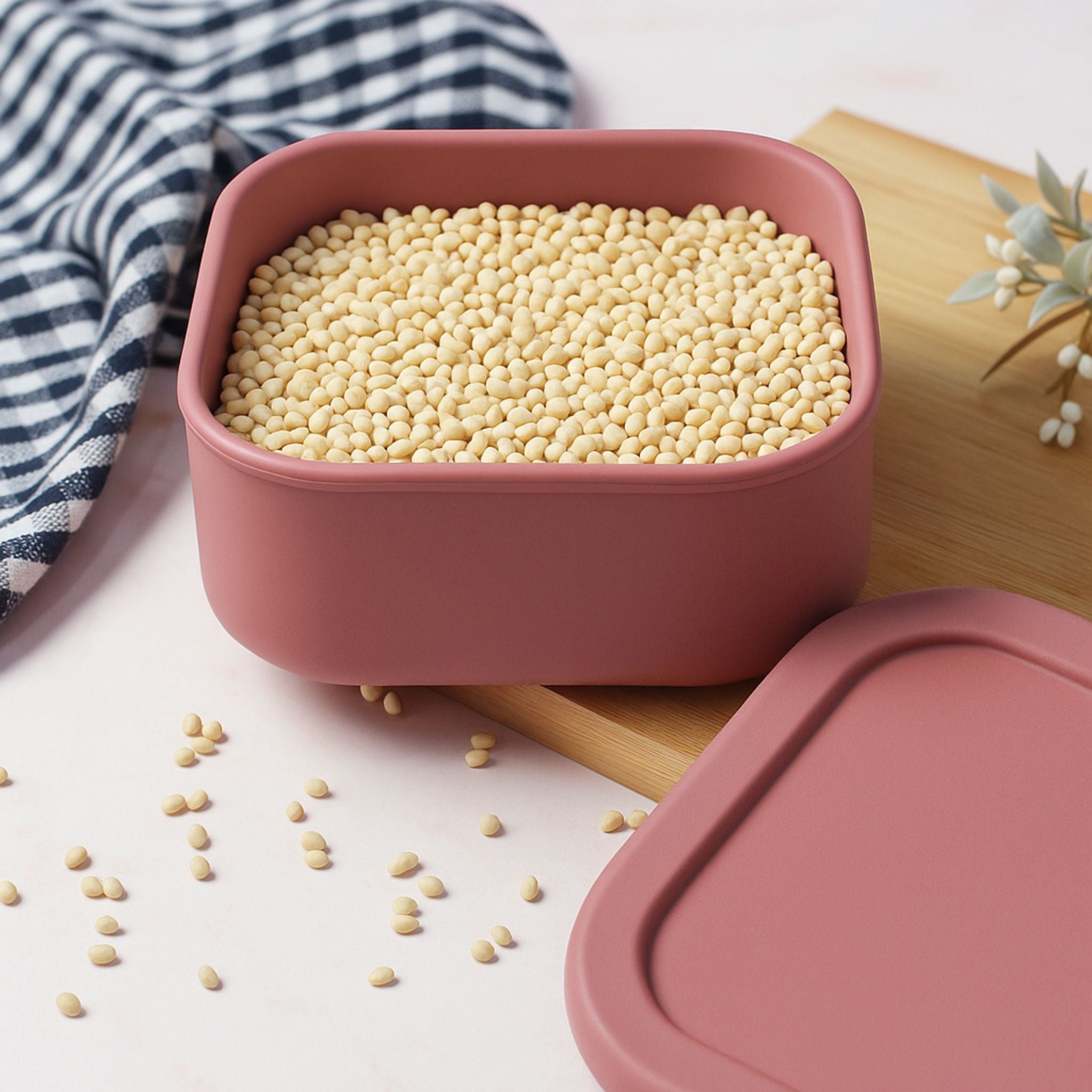 Red ZipNow silicone container filled with yellow pulses on kitchen counter
